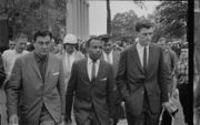 James Meredith walking to class accompanied by U.S. marshals
